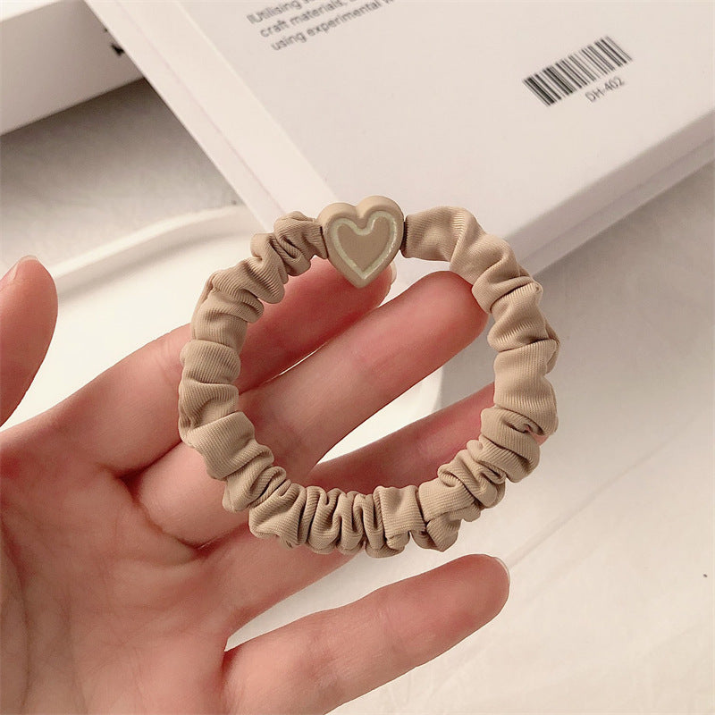 Khaki scrunchie hair tie with a beige heart charm