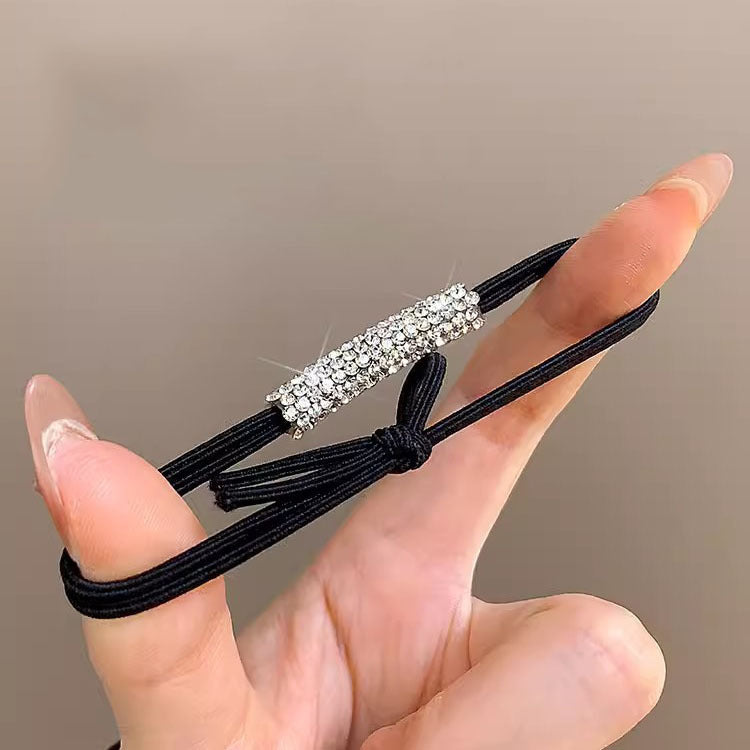 Black ponytail hair tie with a sparkling rhinestone bar