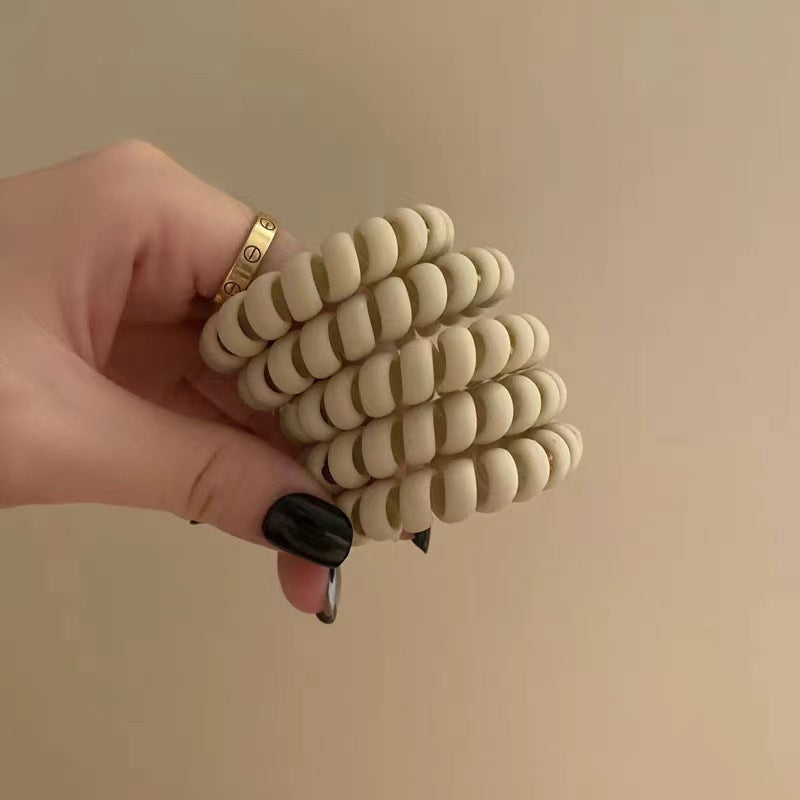 Matte beige spiral telephone-cord hair tie