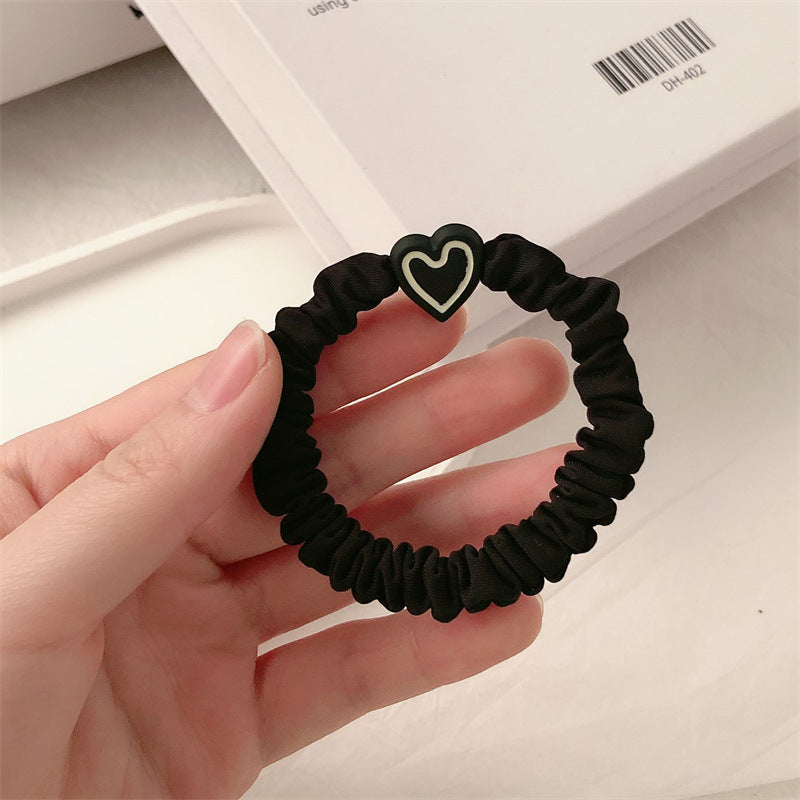 Black scrunchie hair tie with a black and white heart charm