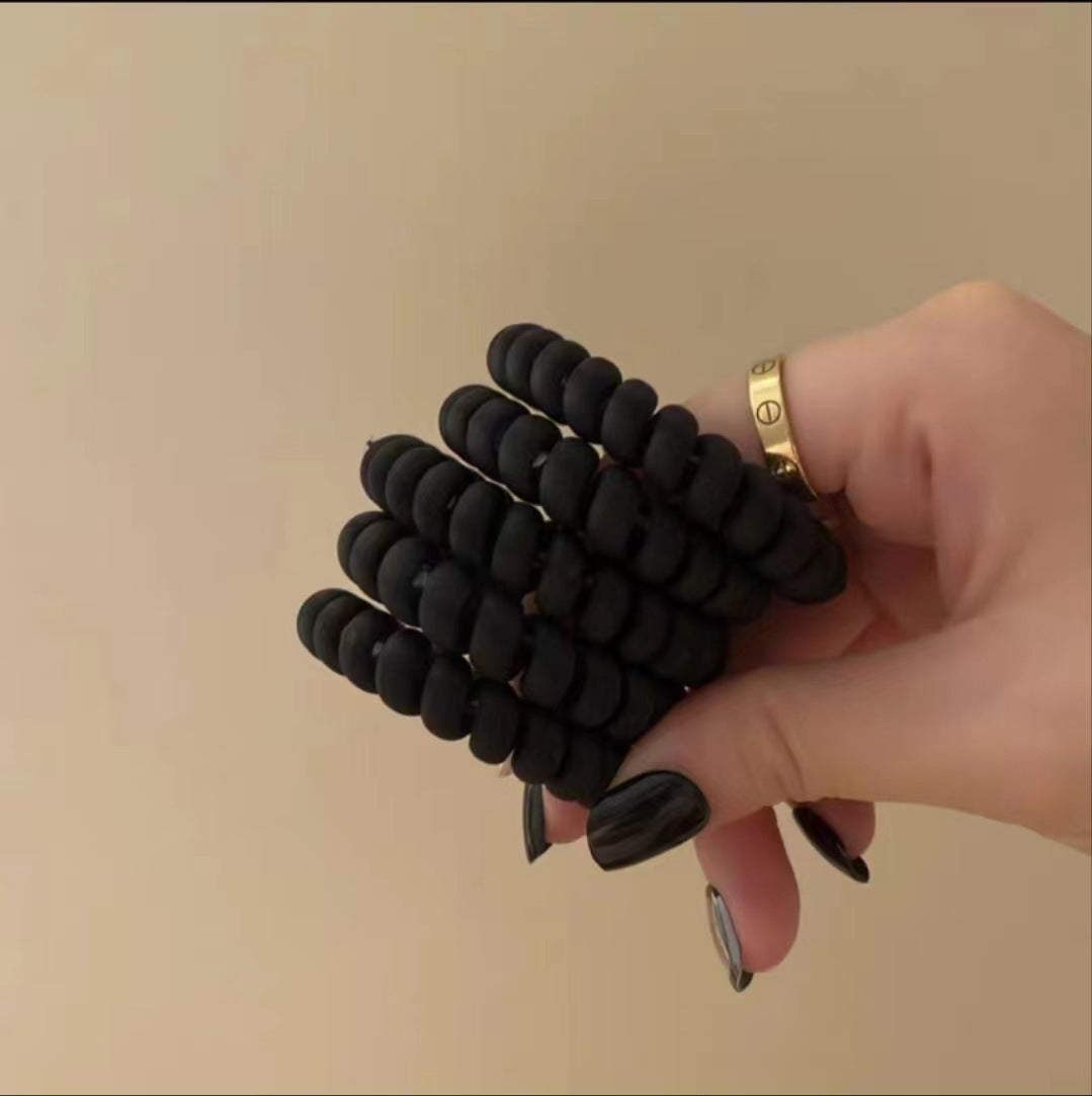 Matte black spiral telephone-cord hair tie