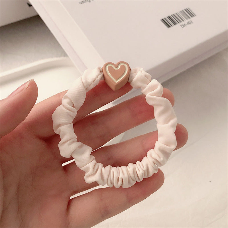 Pink scrunchie hair tie with a dusty pink heart charm
