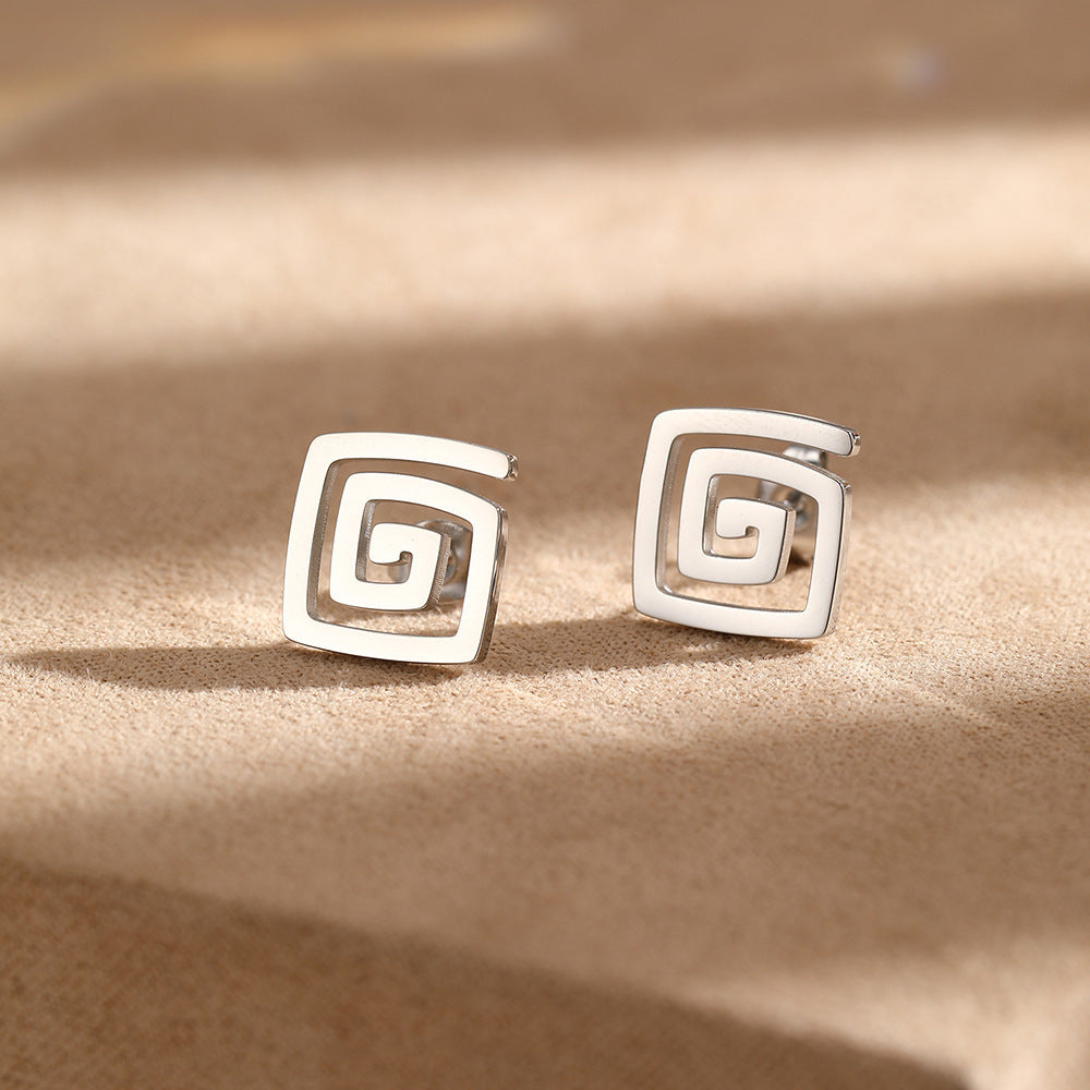 Silver-tone square stud earrings featuring a geometric spiral cutout design